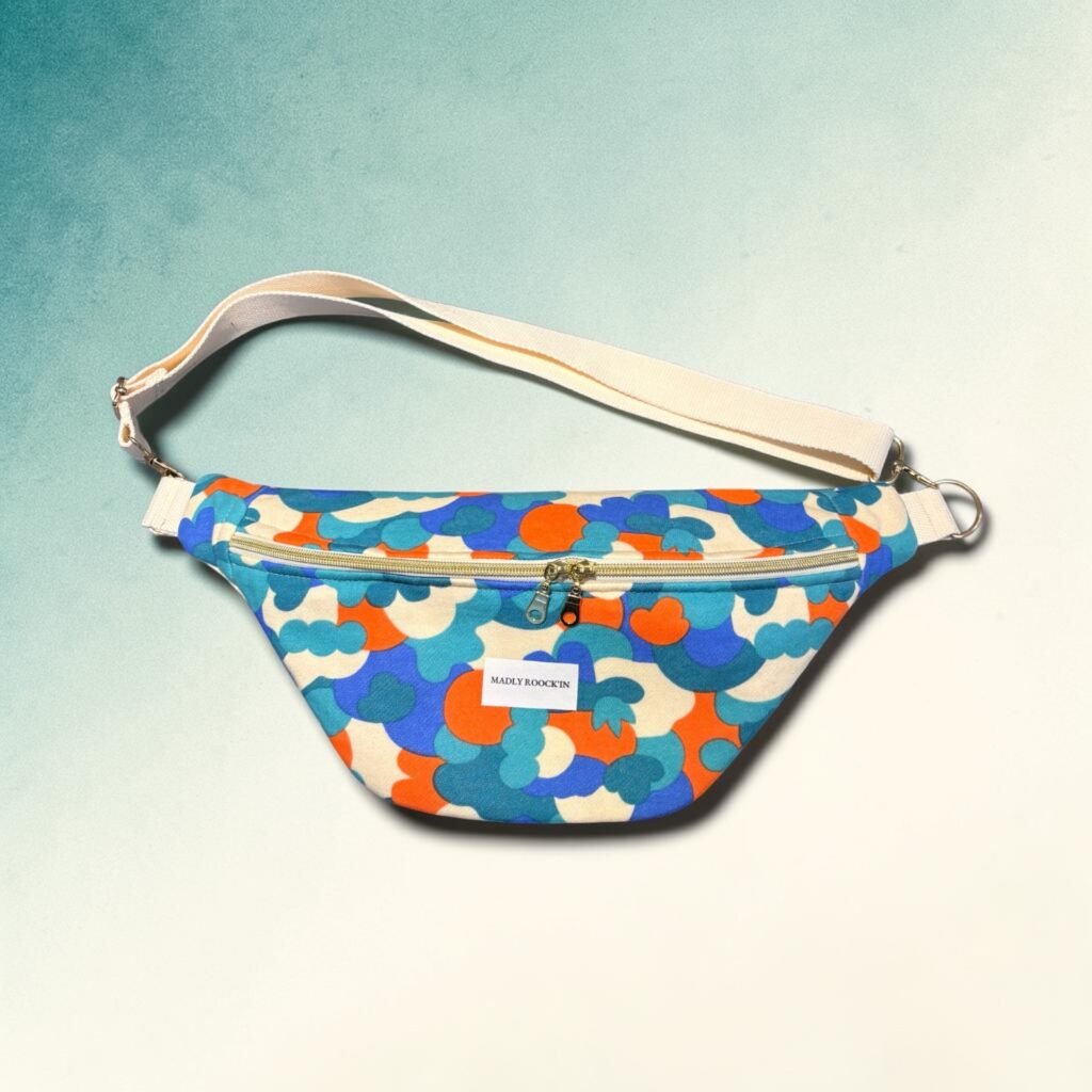 Sac banane Gabriel graphique bleu corail porté en bandoulière par une femme